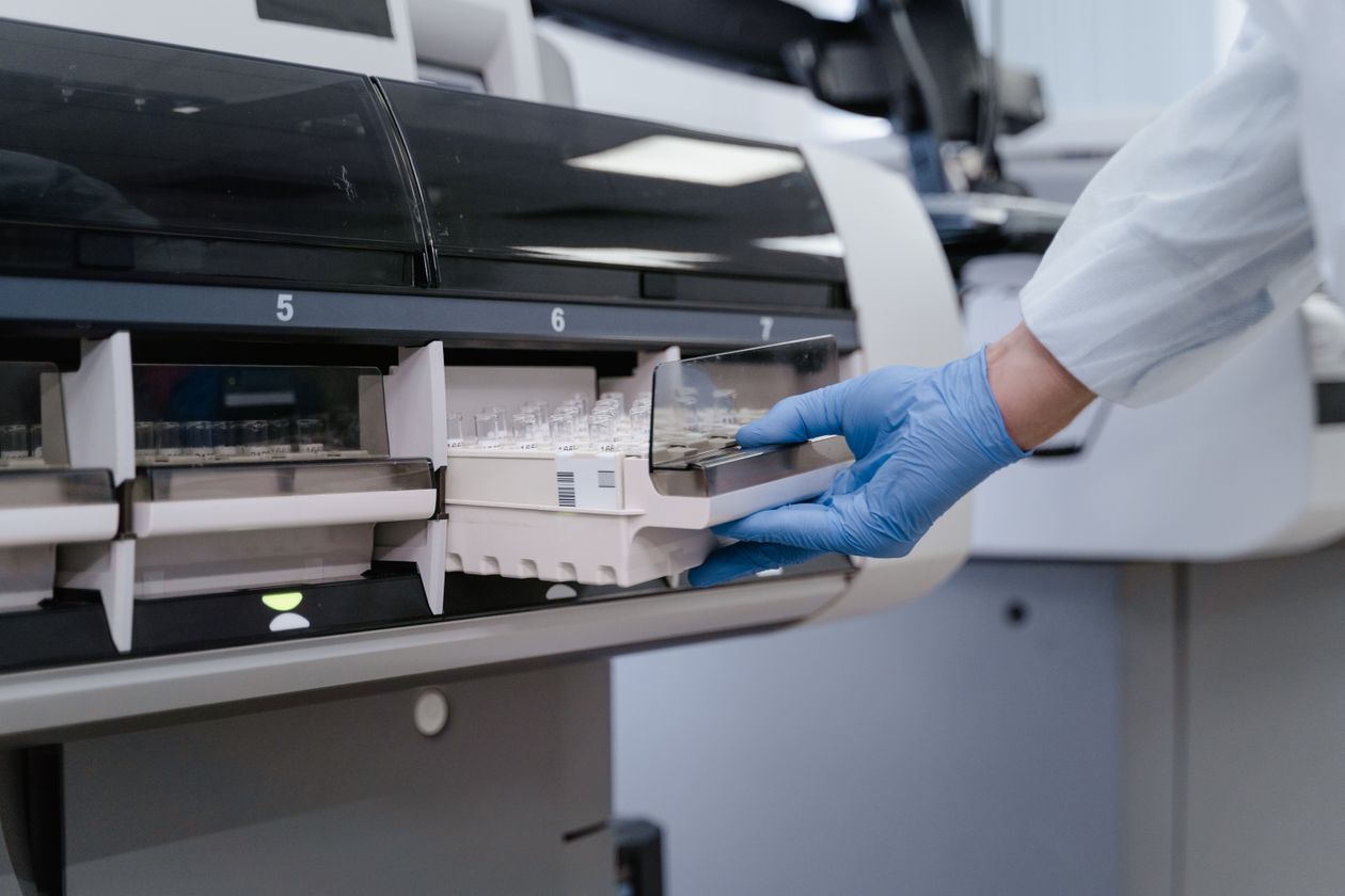 Laboratory technician working with a sample analyzer